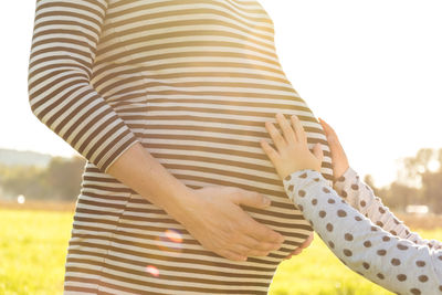 Midsection of women against blurred background