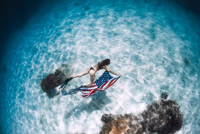 High angle view of man swimming in sea