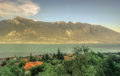 Scenic view of sea and mountains against sky