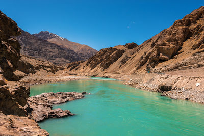 Scenic view of mountains against clear blue sky