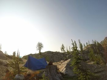 Tent in grass against clear sky