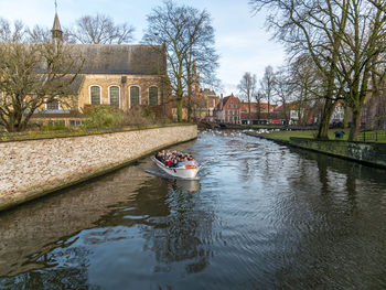 Canal amidst buildings and trees