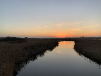 Scenic view of lake against sky during sunset