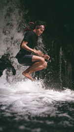 Full length of young man holding water