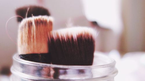 Close-up of make-up brushes on table