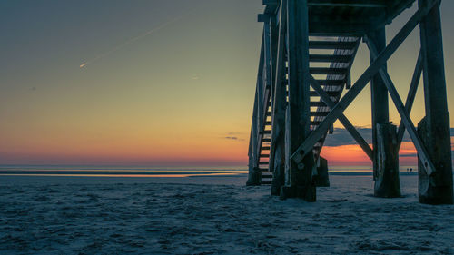 View of bridge over sea at sunset