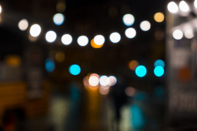 Defocused image of illuminated city street at night