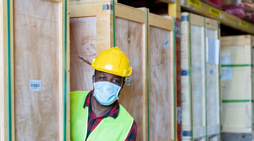 Portrait of worker wearing hardhat and mask