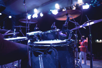 Midsection of person playing drum in event