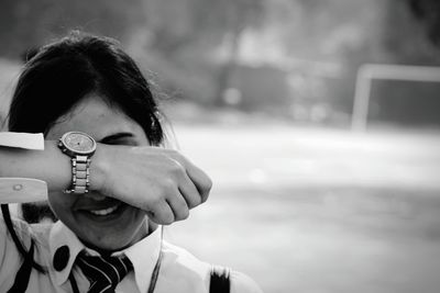 Close-up of girl hiding face with hand