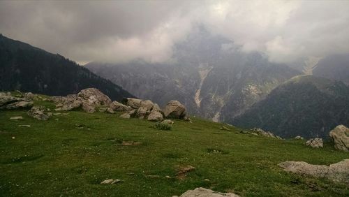 Scenic view of mountains against cloudy sky