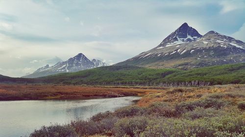 Scenic view of lake and mountains against sky