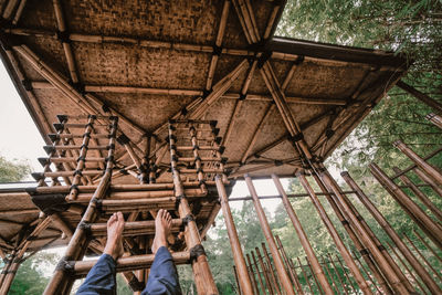 Low section of people in the bamboo gazebo in the park