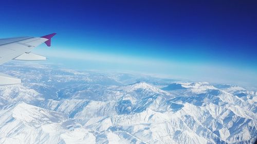 Aerial view of landscape against blue sky