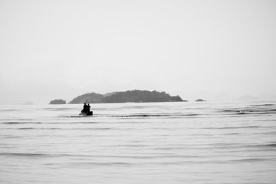 Man on sea against clear sky