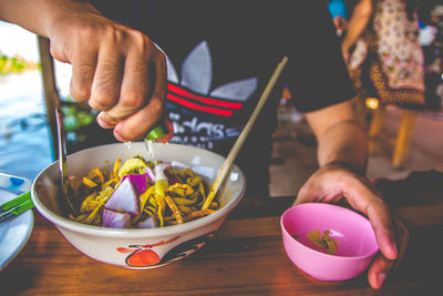 Midsection of man preparing food on table