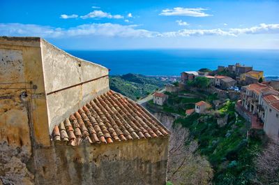 High angle view of townscape by sea against sky
