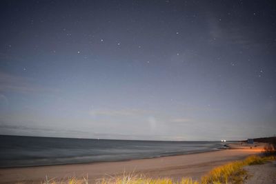 Scenic view of sea against sky at night