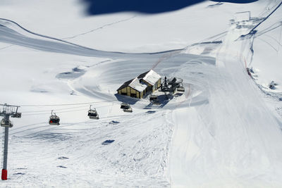 Top view of the ski slope, the chairlift and the two lodges. winter landscape of the ski resort.