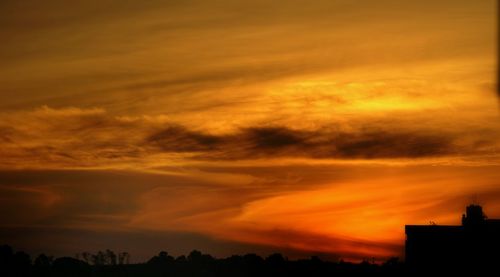 Silhouette of tree against dramatic sky