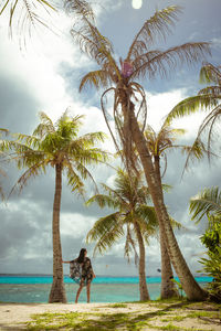 Trees on beach against sky