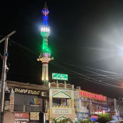 Low angle view of illuminated sign on street at night