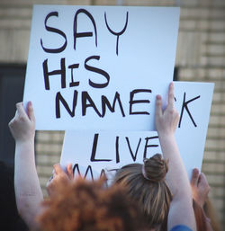 Low angle view of woman hand with text