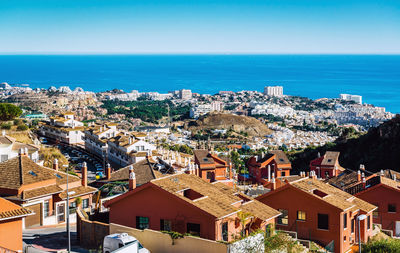 High angle view of houses and buildings by sea against sky at costa del sol