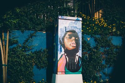 Portrait of smiling woman against plants