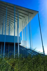 Low angle view of modern building against clear blue sky