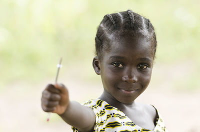 Portrait of boy holding outdoors