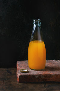 Close-up of juice on table against wall