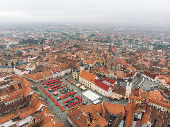 High angle view of buildings in town against sky