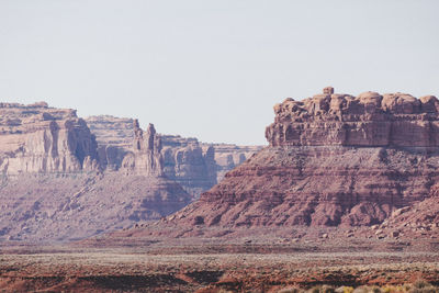 Rock formations on landscape against clear sky