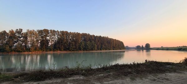 Scenic view of lake against sky during sunset