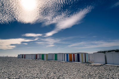 Multi colored sand on beach against sky