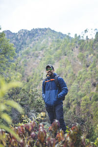 Rear view of man standing in forest