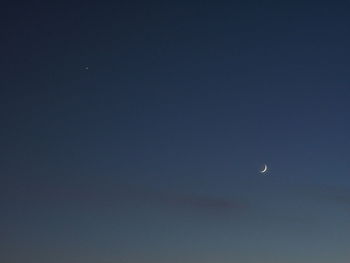 Low angle view of moon against clear sky at night