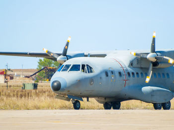 Airplane on runway against clear sky