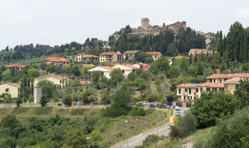 Buildings in town against sky