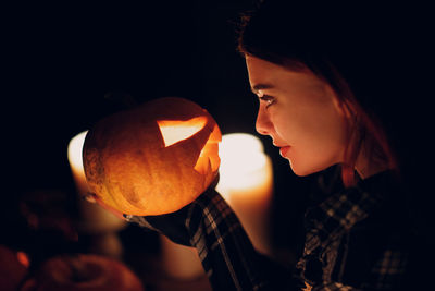 Midsection of woman holding pumpkin