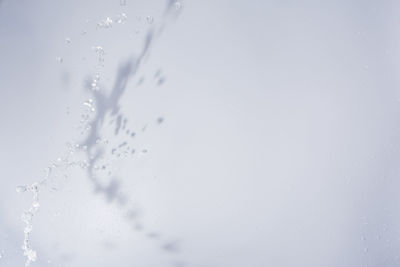 Close-up of water splashing against wall