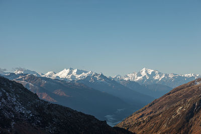 Scenic view of snowcapped mountains against clear sky