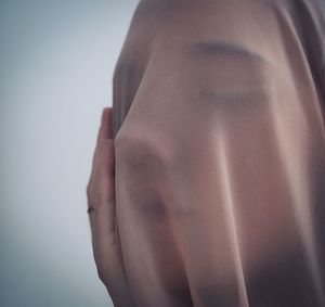 Close-up of woman hand over white background