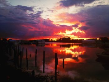 Scenic view of lake against sky at sunset