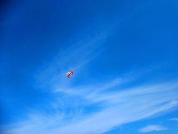 Low angle view of kite flying against blue sky