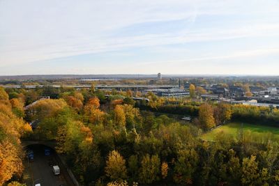 High angle view of trees and buildings against sky