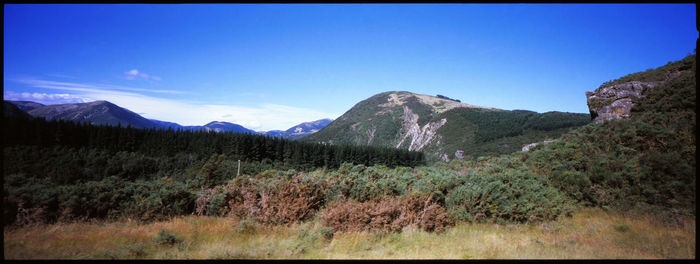 Scenic view of mountains against clear blue sky