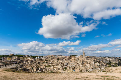 View of sassi di matera against cloudy sky