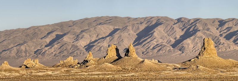 Panoramic view of arid landscape and mountains against sky
